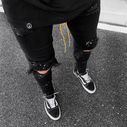 Luxurious Ripped Hole Jeans for Men showcasing a trendy hip hop style, crafted from premium denim for a distressed look ideal for casual occasions.