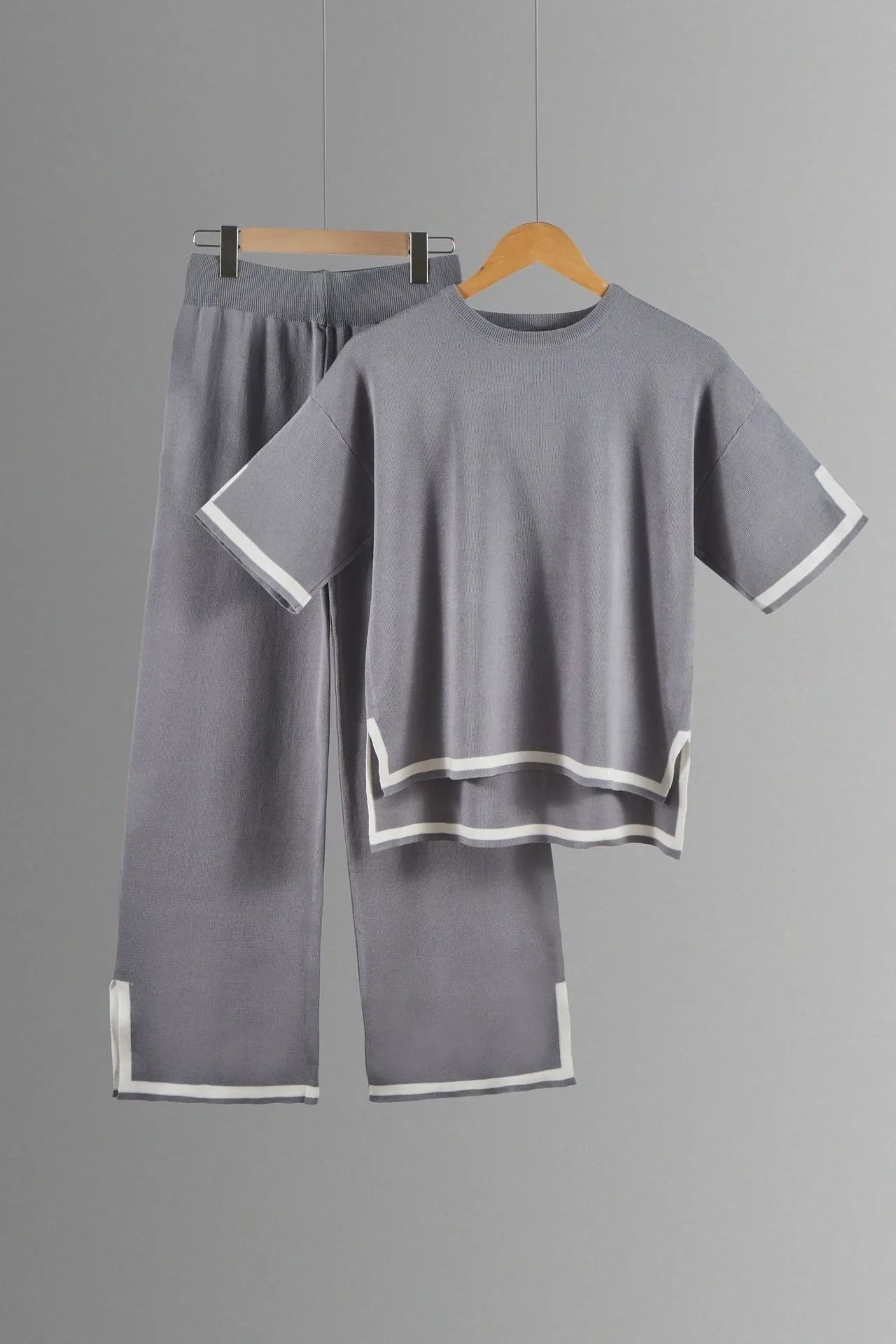 Elegant two-piece women's knitted trousers suit featuring wide-leg pants and a stylish short-sleeved pullover, perfect for sophisticated spring and summer outings.