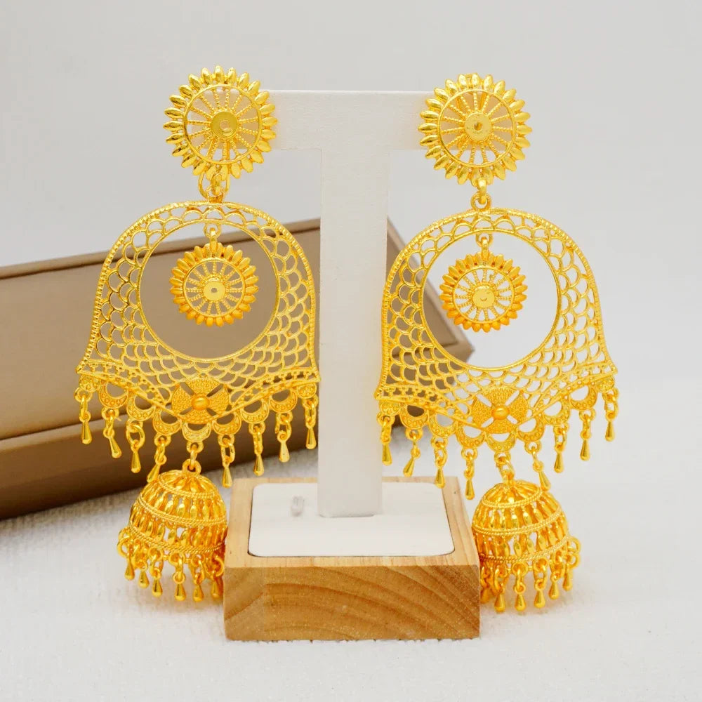 Fashionable copper dangle earrings with intricate geometric pattern, adding a touch of luxury to any formal outfit.