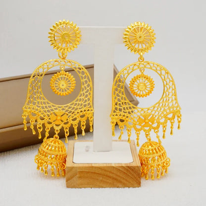 Fashionable copper dangle earrings with intricate geometric pattern, adding a touch of luxury to any formal outfit.