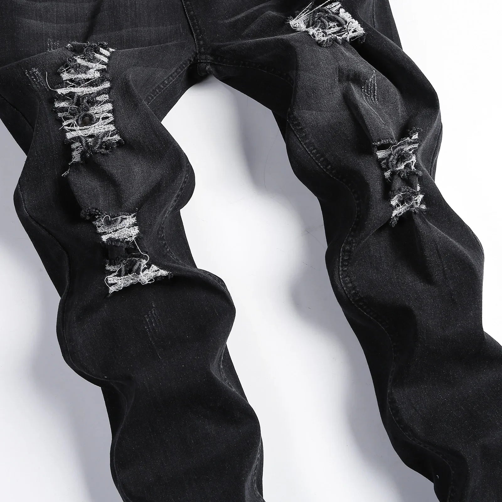 Fashion-forward men's skinny jeans featuring stylish rips, perfect for modern casual wear, tailored for comfort and sophistication.