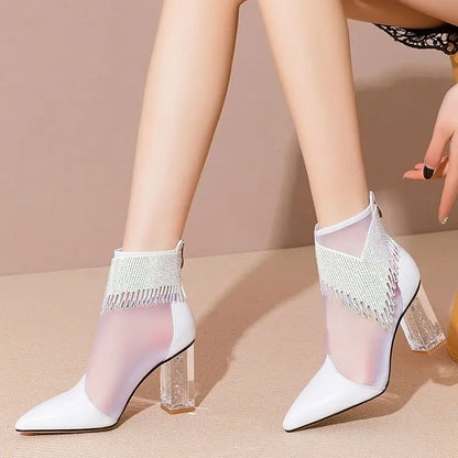 Sleek pointed toe high heel dance boots for women incorporating stunning rhinestones and tassels, made with a functional rubber sole and fashionable lace-up mesh details.