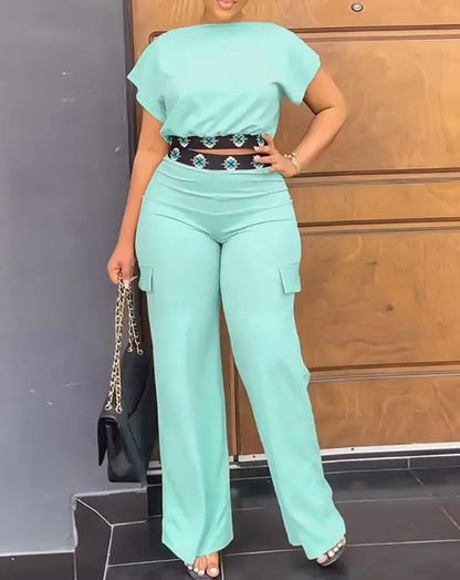 Luxury geometric print two-piece set for women, consisting of a flattering boat neck crop top and stylish high waist ankle-length trousers, designed for summer elegance.