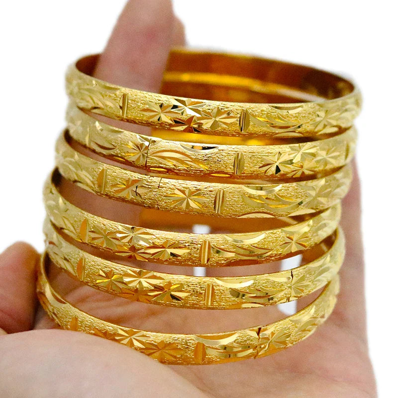 Charming gold bangles set with a fashionable ethnic design, embodying luxury and tradition, suitable for all compatible looks.