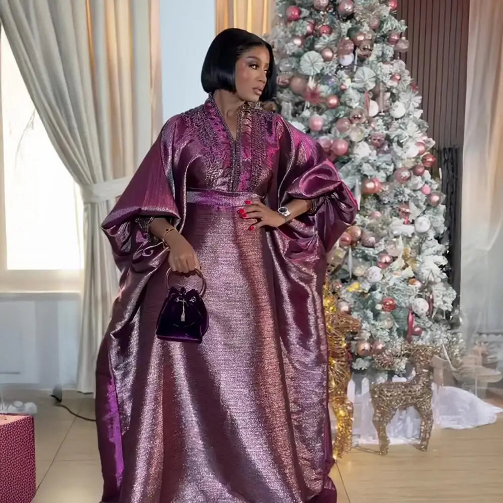 A model elegantly wearing a luxury V-neck turkey dress adorned with rhinestones, demonstrating a stunning fit ideal for traditional African church style.