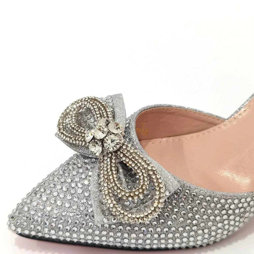 Elegant handbag matching luxury women's rhinestone bow party shoes, perfect for special occasions.