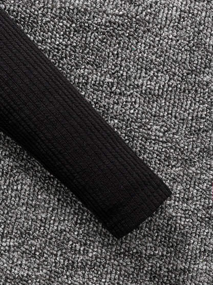 Full view of a luxury 2-piece children's autumn fashion set, showcasing a blend of a black top and stylish camouflage skirt, ideal for young girls.