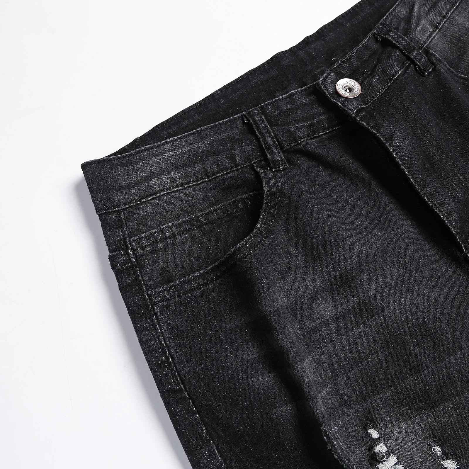 Luxury men's jeans featuring a mid-rise waist and stylish ripped accents, tailored for a modern silhouette.