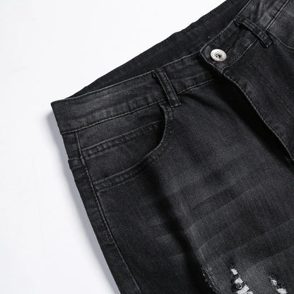 Luxury men's jeans featuring a mid-rise waist and stylish ripped accents, tailored for a modern silhouette.