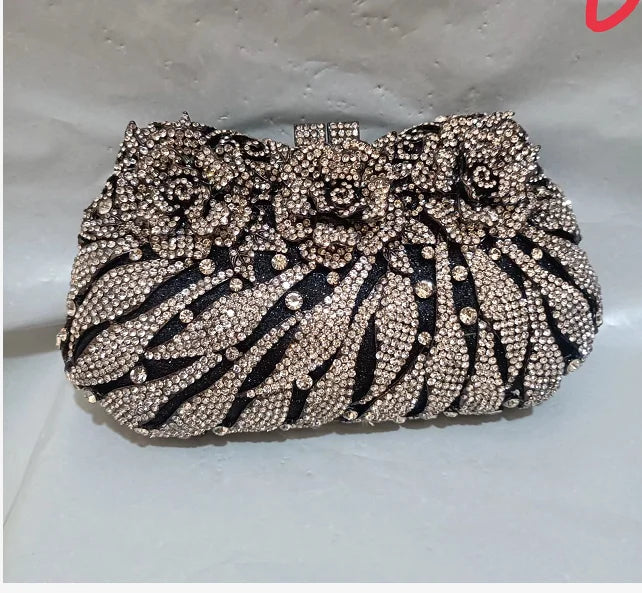 Sleek metallic minaudiere clutch bag for women, adorned with rhinestones, ideal accessory for upscale evening events.