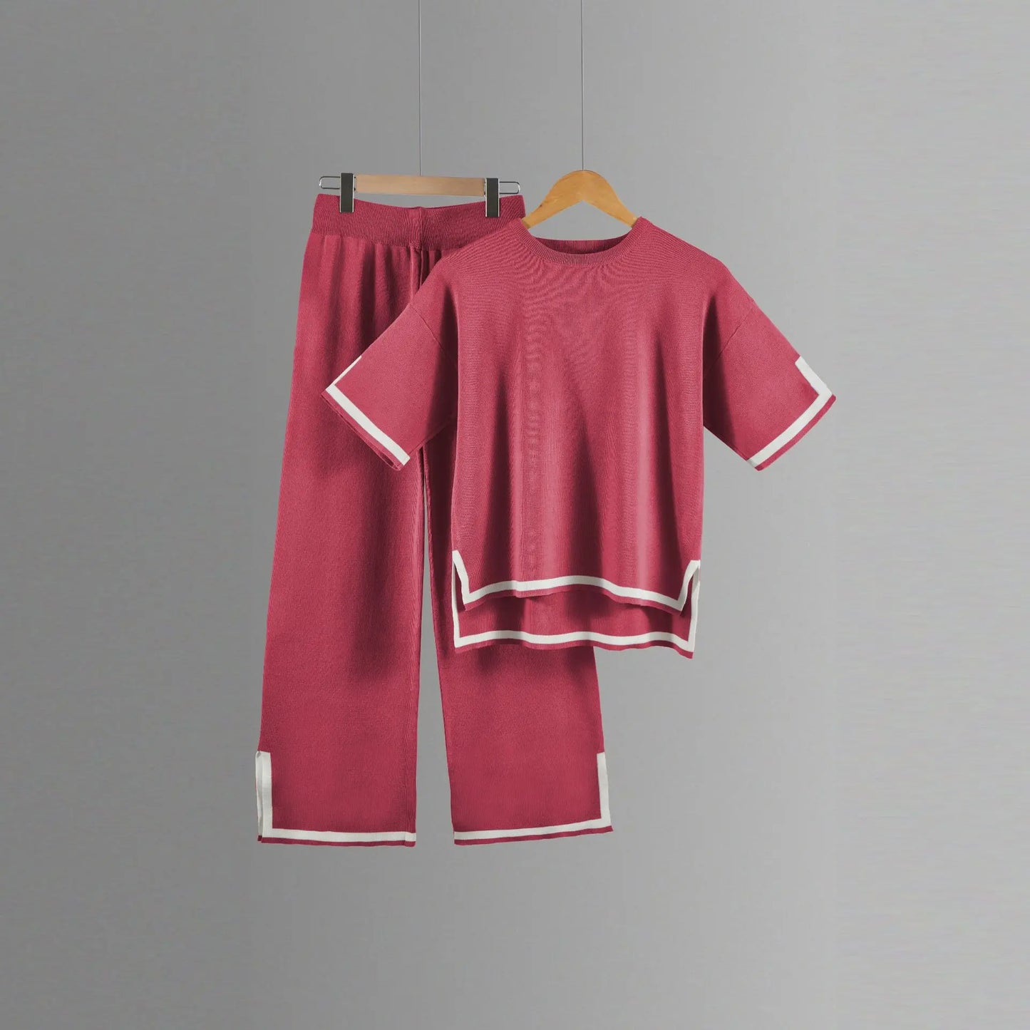 Close-up of the soft polyester fabric of a two-piece women's knitted suit, showcasing fine craftsmanship and luxurious comfort.