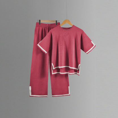 Close-up of the soft polyester fabric of a two-piece women's knitted suit, showcasing fine craftsmanship and luxurious comfort.