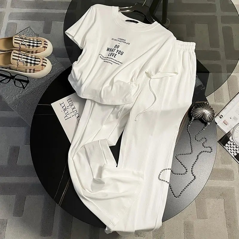 Fashion-forward women's two-piece set, featuring a refined short sleeve top and airy wide leg pants, ideal for a luxurious summer outing.