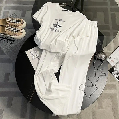 Fashion-forward women's two-piece set, featuring a refined short sleeve top and airy wide leg pants, ideal for a luxurious summer outing.