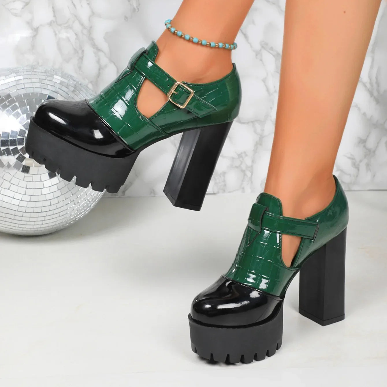 Close-up view of luxury women's slip-on pumps with stylish mixed colour patterns and a comfortable square heel.