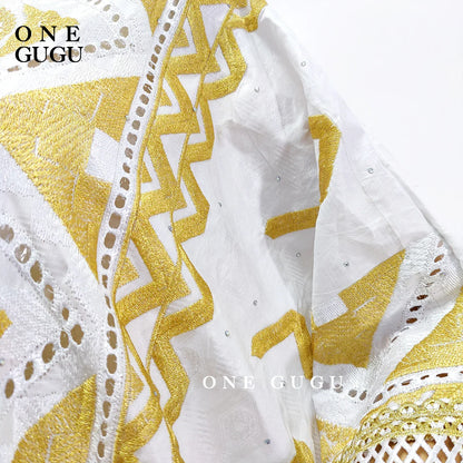 Elegant Original Nigerian Bazin Dress Dashiki in white and gold brocade, adorned with intricate embroidery, ideal for special occasions and traditional events for women.