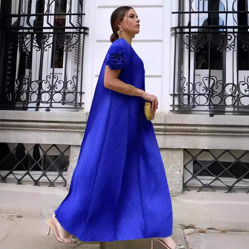 Close-up of luxurious polyester fabric of the maxi dress highlighting intricate folds and a flattering silhouette.