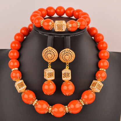Elegant Nigerian bridal jewelry set featuring a stunning necklace, bracelet, and earrings adorned with vibrant artificial coral beads, perfect for weddings.