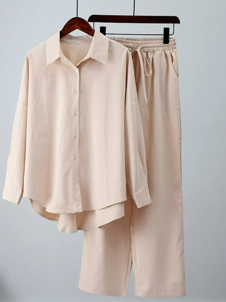 Chic model showcasing the complete Luxury Women's Casual Spring/Summer Outfit Set with a loose elastic long sleeve shirt and elegant wide leg pants, perfect for sophisticated summer outings.