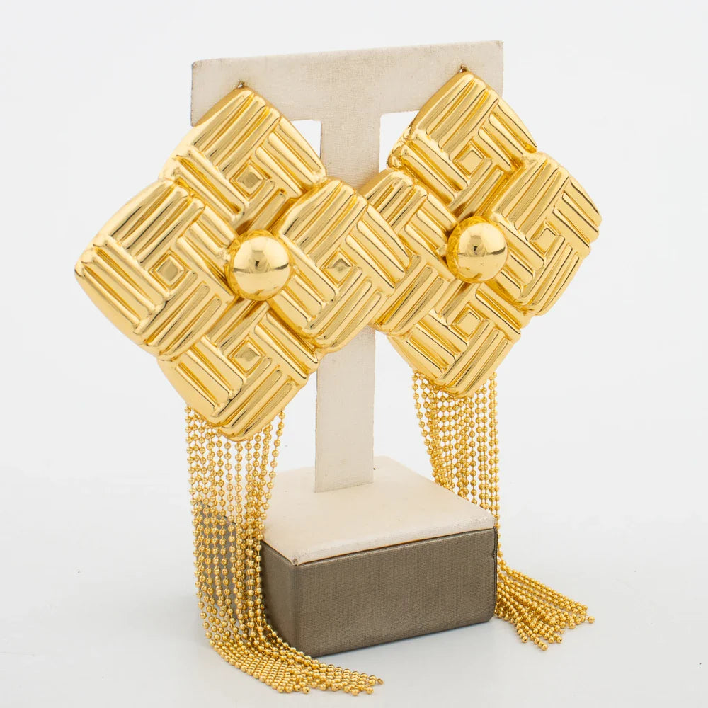 Eye-catching ethnic gold tassel earrings displayed elegantly, perfect for adding a touch of glamour to any outfit for women.