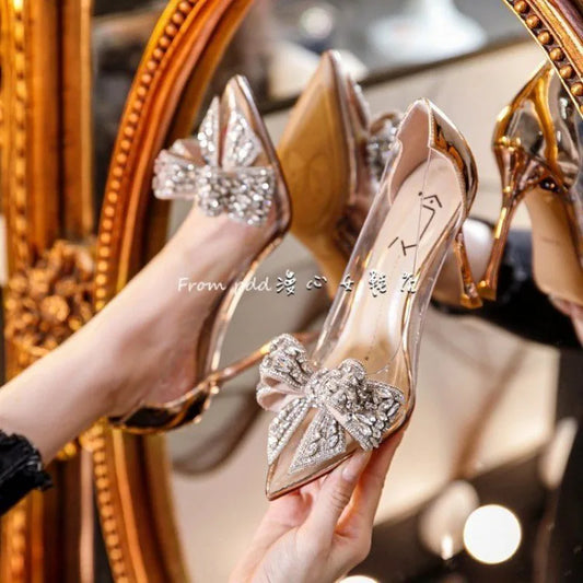 Elegant rhinestone bow transparent high heel sandals for women, showcasing a modern fashion style ideal for formal wear, featuring thin heels and a luxurious finish.