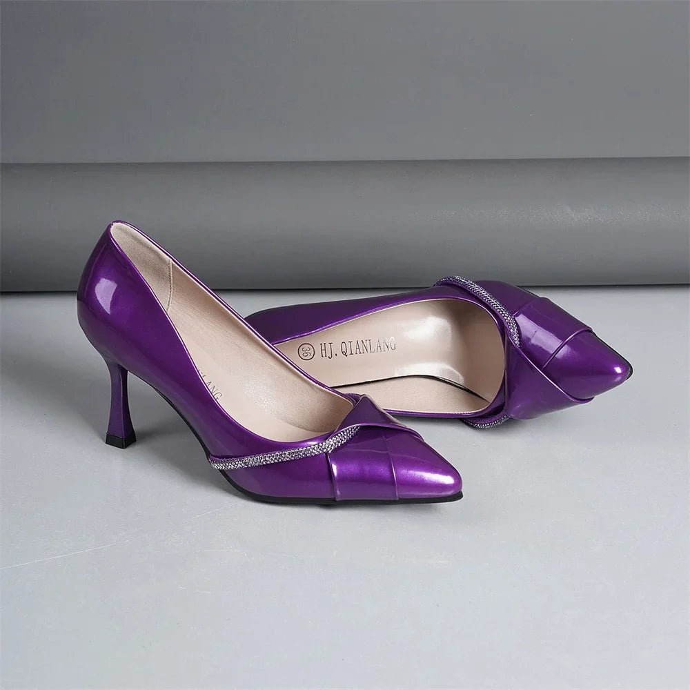 Sophisticated purple pumps with a pointed toe and high thin heels, ideal for enhancing any woman's outfit for weddings or casual outings.