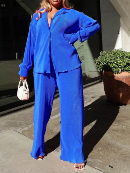 Close-up detail of the pleated shirt from QFAF's elegant outfit, highlighting fine craftsmanship and premium polyester-spandex blend material.