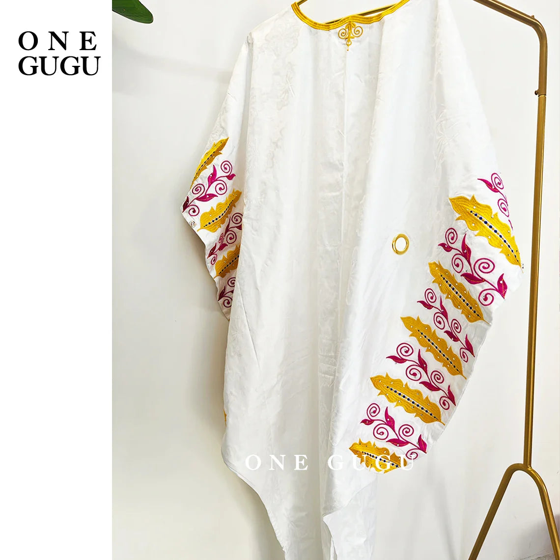 Detailing of the exquisite embroidery and lace decoration on a luxury royal blue boubou dress, ideal for special occasions.