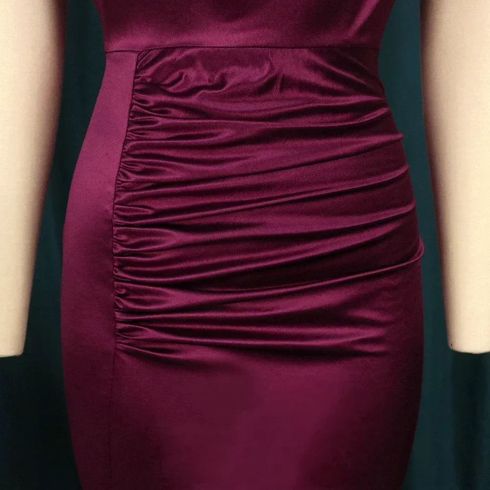 Chic Bodycon Dress in Burgundy, designed for the modern woman, featuring an elegant slit and tasteful folds.