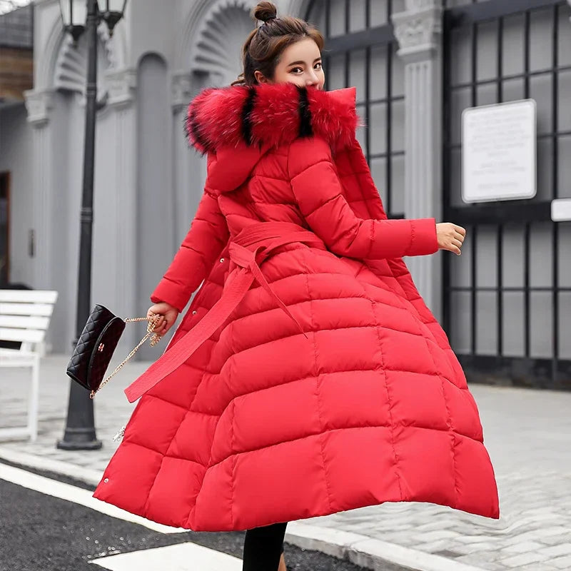 Women's elegant long coat with a luxurious fox fur collar, featuring a stylish bow belt and pockets, perfect for winter fashion and office wear.