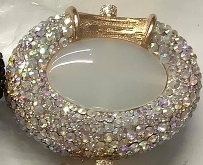 Chic women's evening minaudiere bag with a dazzling metallic design and crystal accents, a statement piece for luxury occasions.