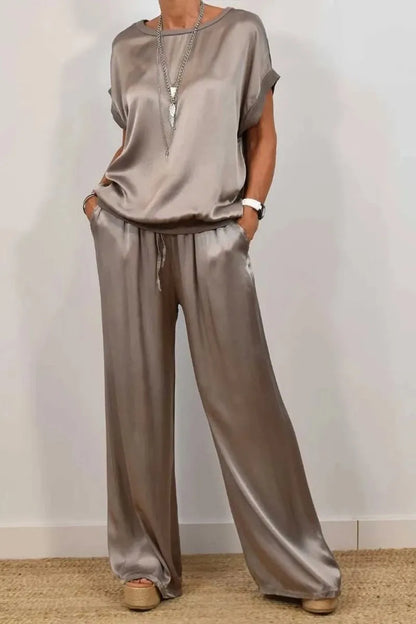 Model wearing a luxurious satin t-shirt and wide-leg pant set, exuding elegance and comfort for summer outings.