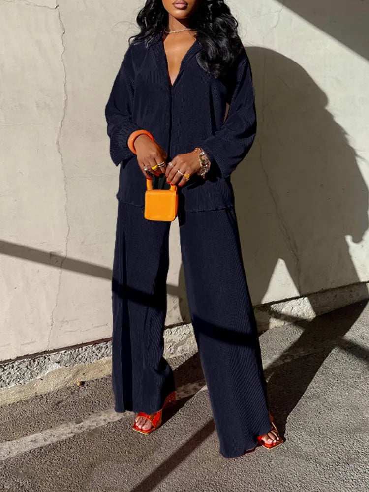 Luxurious pleated shirt and high waist wide leg pants set for women, presenting a stylish casual look for any occasion.