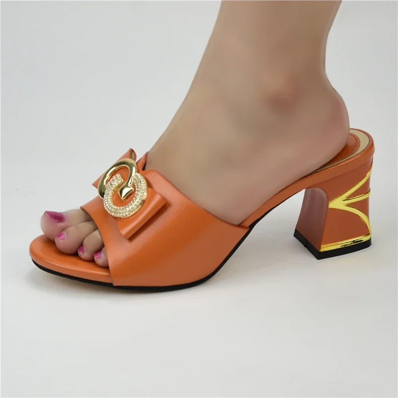 Luxurious gold and orange high heeled sandals for women, featuring a square heel design and exquisite rhinestone detailing, ideal for special occasions.