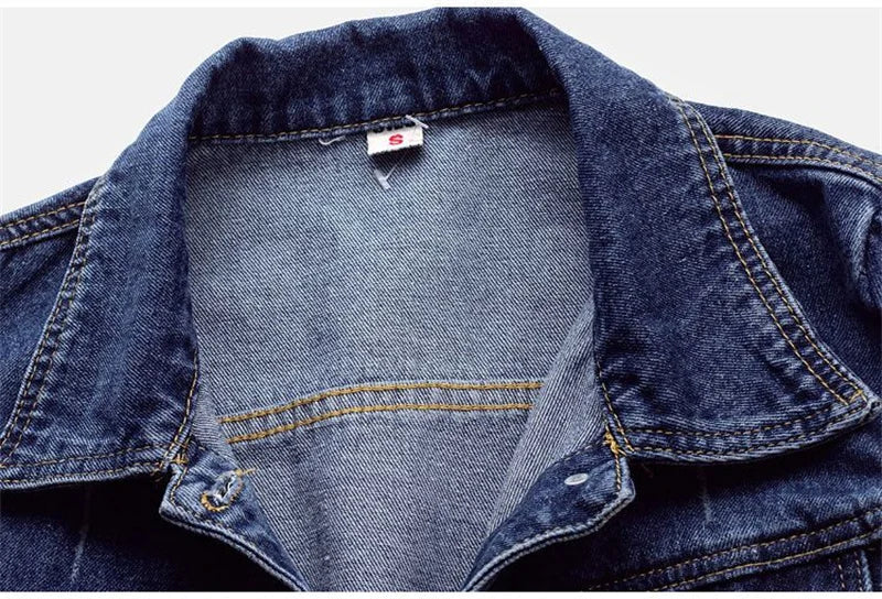 Close-up of the premium fabric texture of a luxury women's denim jacket showcasing its soft polyester and cotton blend.