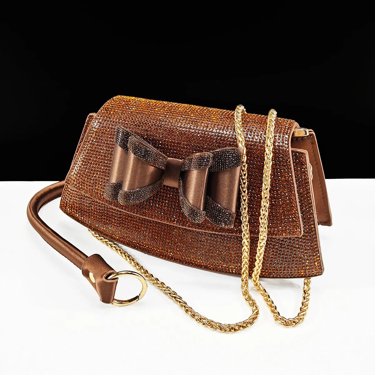 Luxury handbag with long chain shoulder strap, designed to complement the elegant women's rhinestone butterfly shoes, ideal for formal events.