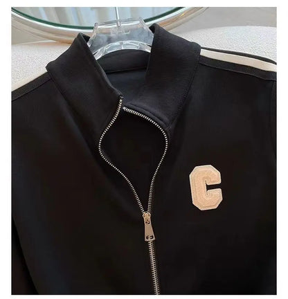 Stylish women's autumn winter outfit featuring a beautifully embroidered coat and flattering wide-leg pants, perfect for a fashionable and comfortable look.