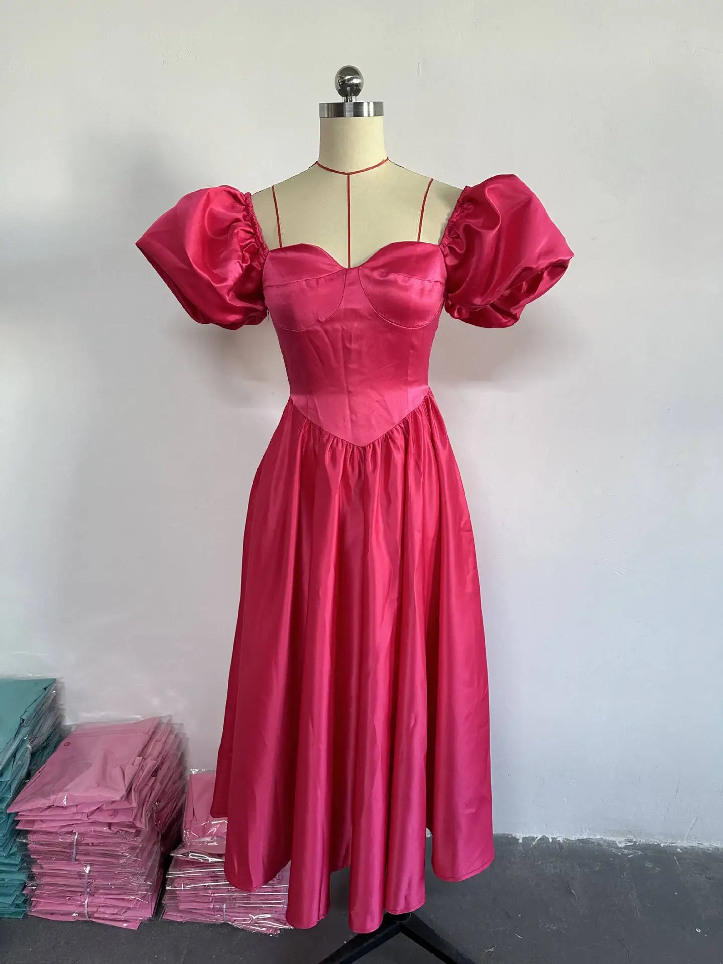Elegant deep pink A-Line midi dress featuring a sweetheart neckline, puff sleeves, and a stylish backless design, perfect for special occasions.