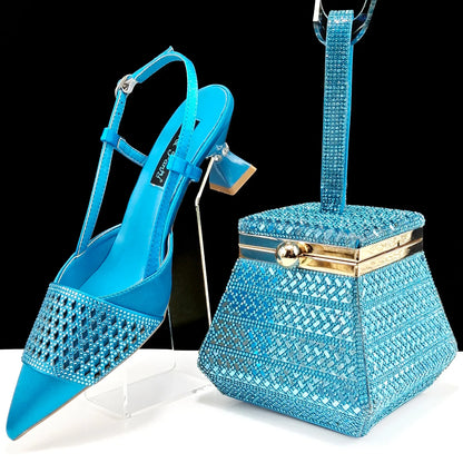 Stylish black gold handbag with a chic buckle strap, complementing elegant women's party shoes.