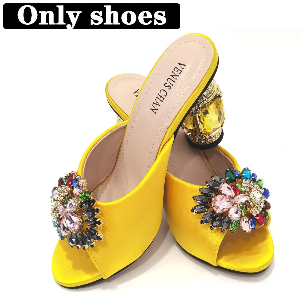 Fashion model wearing yellow rhinestone embellished stiletto heels and matching evening bag, exuding luxury and elegance.