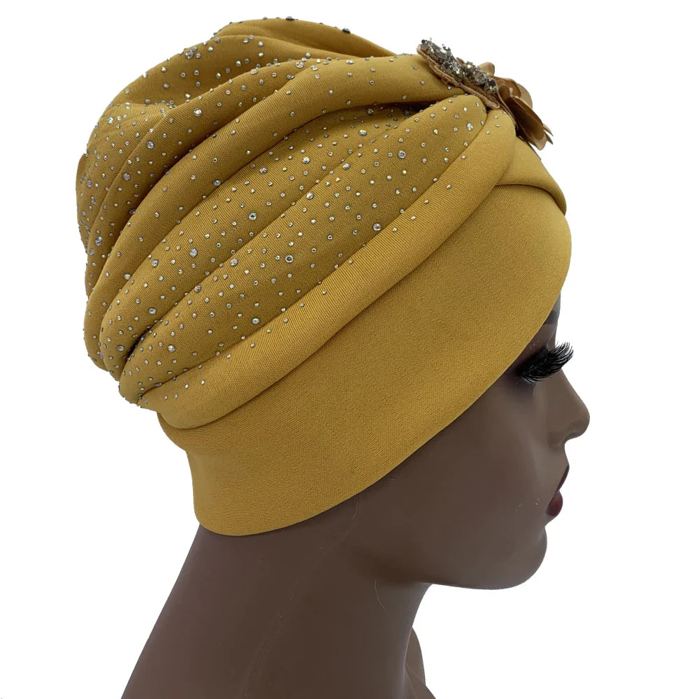 Stylish African turban cap in polyester, combined with decorative rhinestones, offering a blend of comfort and luxury for women.