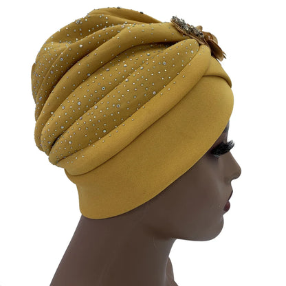Stylish African turban cap in polyester, combined with decorative rhinestones, offering a blend of comfort and luxury for women.