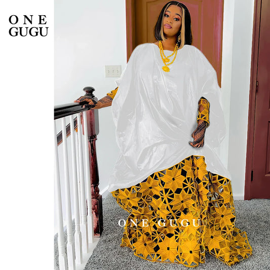 Luxurious gold and white African Bazin dress robe for women, featuring elegant long sleeves and traditional dashiki style for classy occasions.