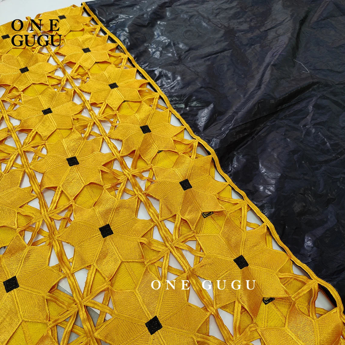 Detailed close-up of the African Bazin gown showcasing intricate lace and stone embellishments, highlighting its elegant craftsmanship.