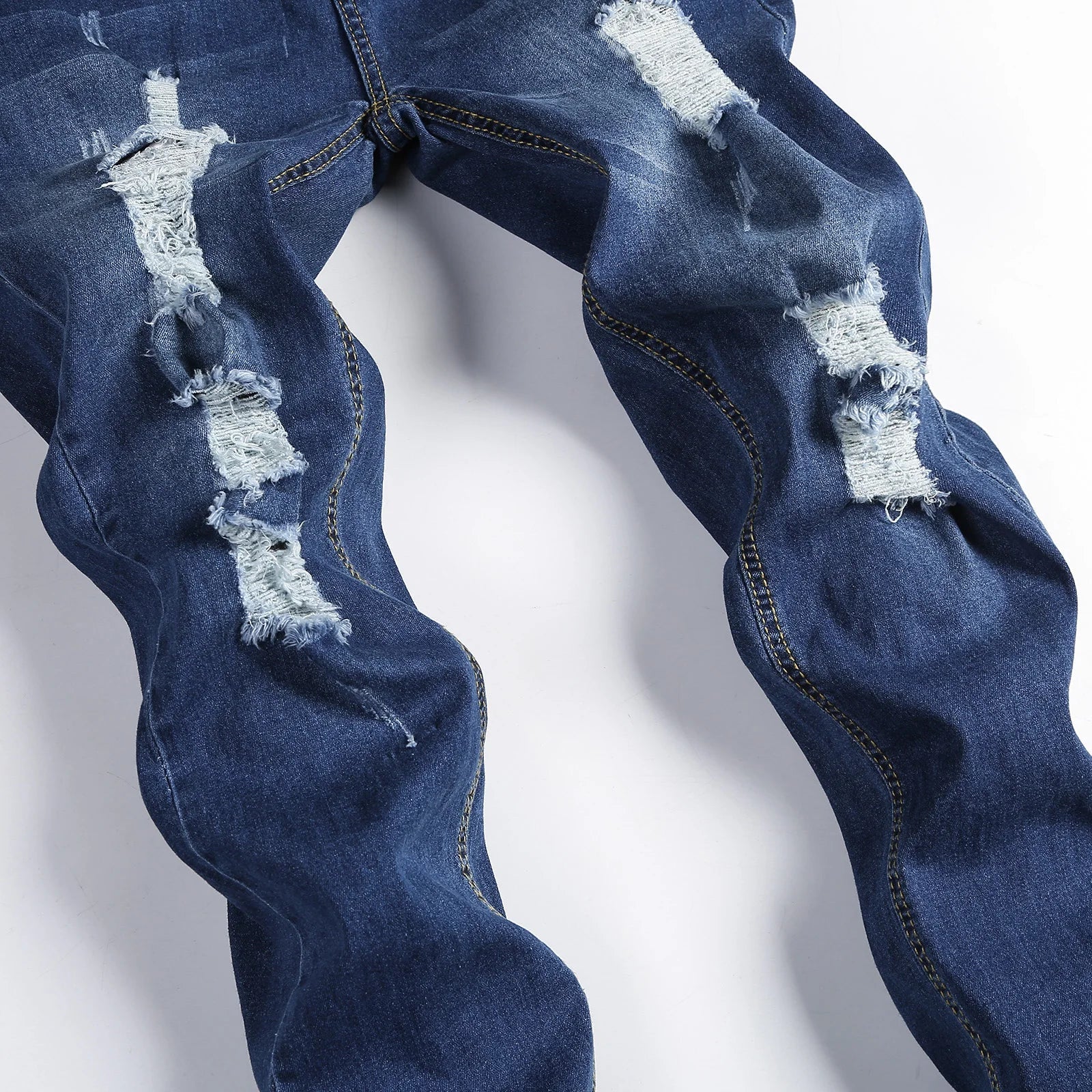 Chic men's ripped skinny jeans showcasing a contemporary vintage stonewashed finish, ideal for casual wear and stylish everyday outfits.