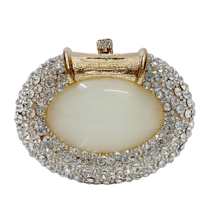 Sleek metallic clutch bag with a minimalist design, embellished with crystals for a luxurious evening accessory.