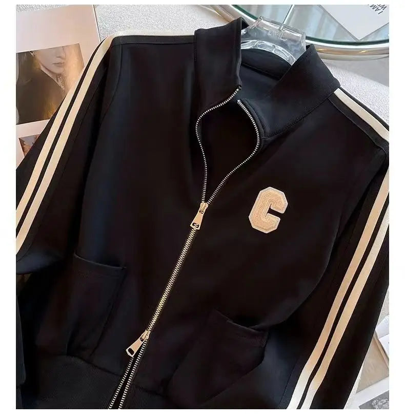 Trendy women's two-piece sports set showcasing an exquisitely embroidered coat and comfortable wide-leg pants, designed for sophisticated casual wear.