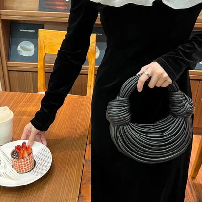 Chic shoulder bag formed from soft materials, highlighting the luxury of handwoven craftsmanship in an elegant gold finish.