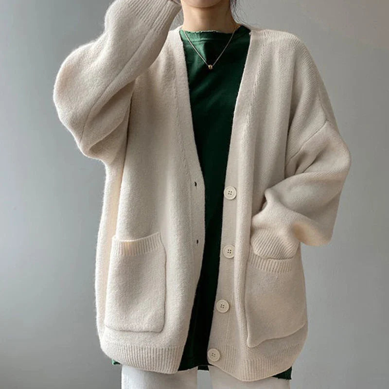 Versatile yellow knitted cardigan, embodying a harmonious blend of comfort and sophistication for the modern woman's wardrobe, suitable for multiple seasons.