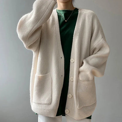 Versatile yellow knitted cardigan, embodying a harmonious blend of comfort and sophistication for the modern woman's wardrobe, suitable for multiple seasons.